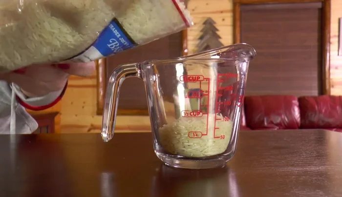 Add 1 1/3 cups of rice to the rain stick.