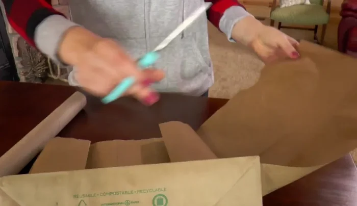 Cut off the other side of the paper sack.