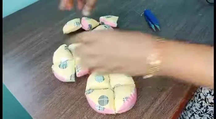 Join all four squares together by stitching their edges, forming the final ball shape.