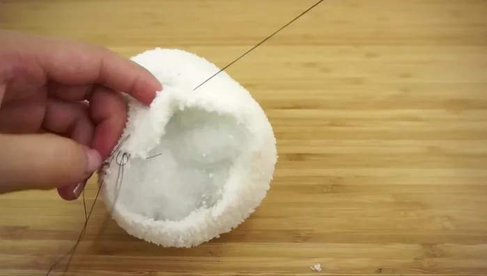 Close the head opening with a running stitch.