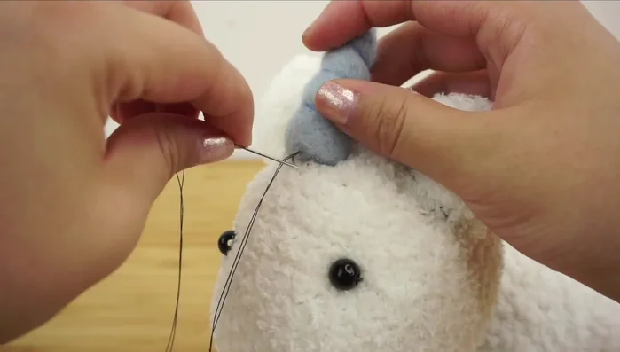 Attach the horn using a ladder stitch.