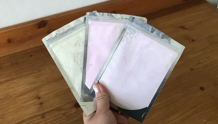 Apply color-changing pigment using hairspray and a brush, testing in sunlight.