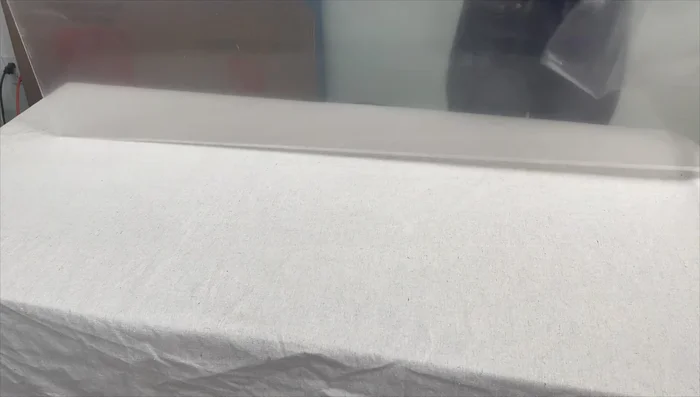 Prepare your design. Arrange leaves or other foliage on the dry fabric, securing them with tape to a plexiglass plate if using large fabric.