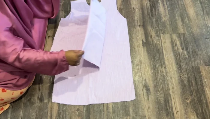 Measure down four inches from the wrist. Draw a rectangle, connecting lines to create the sleeve shape. Cut out the sleeves.