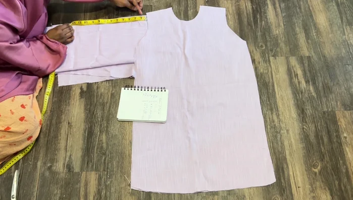 Measure down four inches from the wrist. Draw a rectangle, connecting lines to create the sleeve shape. Cut out the sleeves.