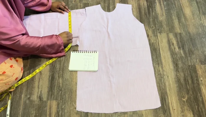 Measure down four inches from the wrist. Draw a rectangle, connecting lines to create the sleeve shape. Cut out the sleeves.
