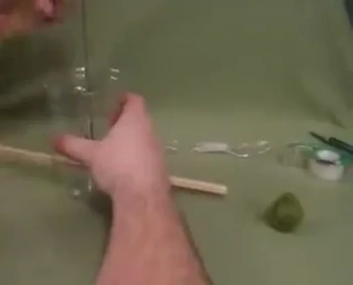 Feed the twine/yarn underneath the dowel.