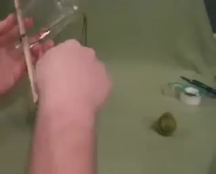 Feed the twine/yarn underneath the dowel.