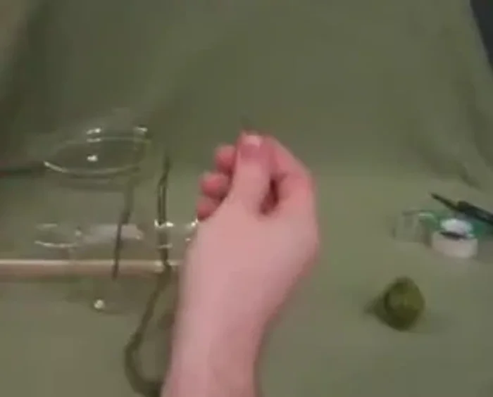 Place the filled terracotta pot on top of the dowel and spoons.