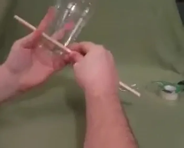 Feed the twine/yarn underneath the dowel.