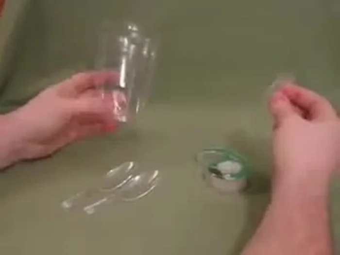 Tape the two spoon handles together securely.