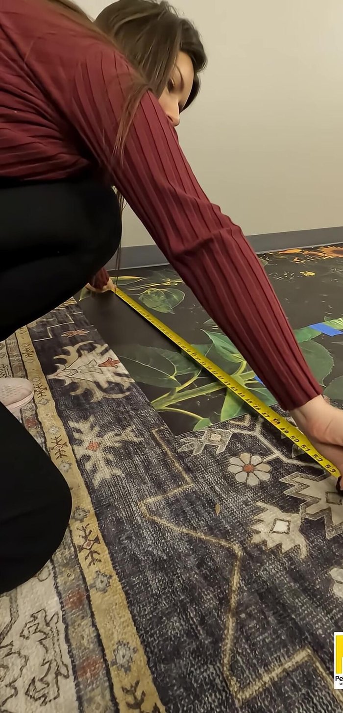 Measure and mark the wall for the first panel (considering the 1-inch bleed). Use a level to mark two points 3 feet apart vertically.