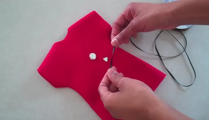 Decorate the dress with ribbons, lace, buttons, puff paint, etc.