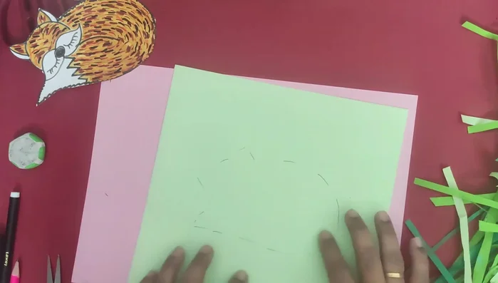 Paste the green paper strips to create a grass effect.