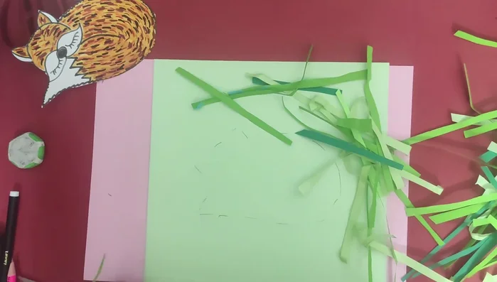 Paste the green paper strips to create a grass effect.