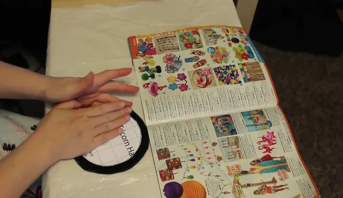 Spray the back of the cardstock with glue and center it on each fabric piece, leaving an allowance around the edges (except for the center hole of the brim). Fold over the excess fabric and glue it down.