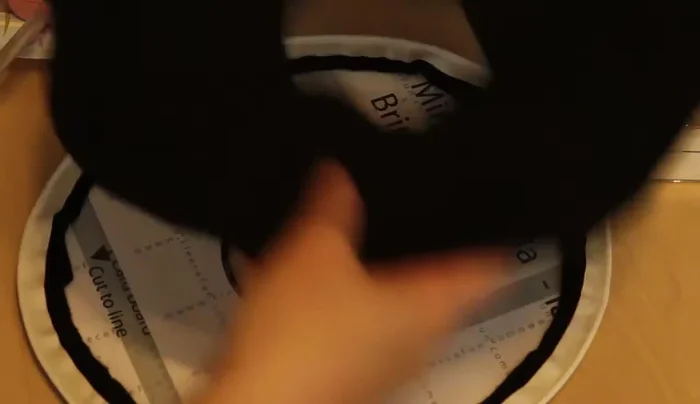 Glue the smaller brim piece onto its cardstock base, ensuring the edges are well-glued.