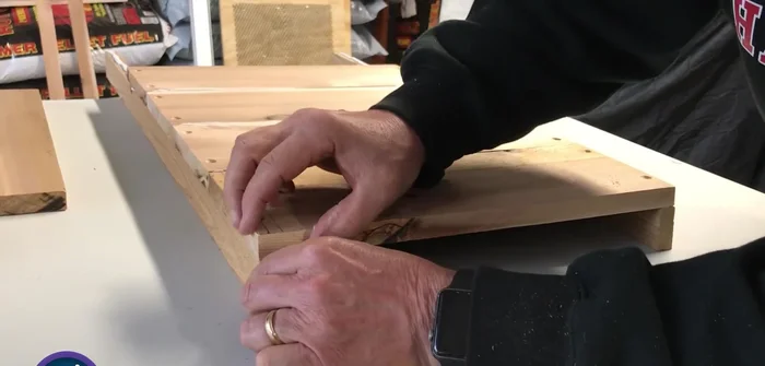 Attach the fifth board, leaving a small gap for air, and cut off any overhang.