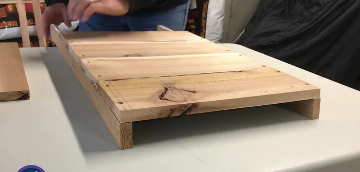 Attach the fifth board, leaving a small gap for air, and cut off any overhang.