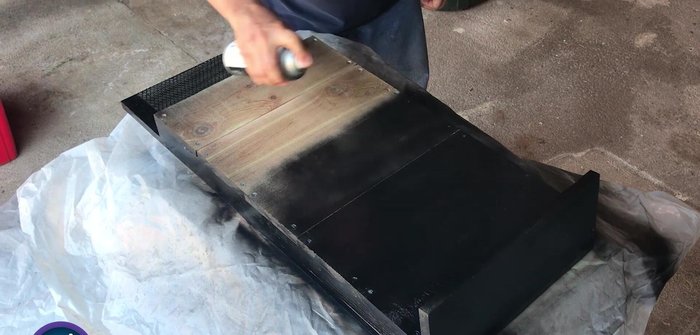 Sand the entire project and paint it black.