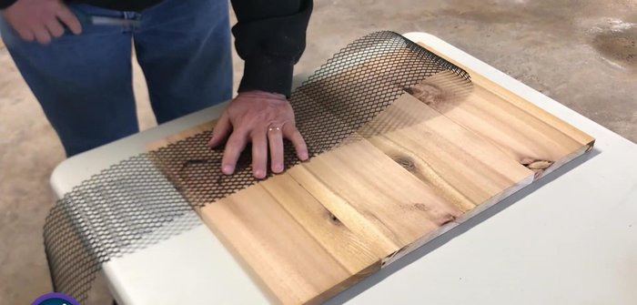 Attach the mesh to one side of the plywood using a staple gun.