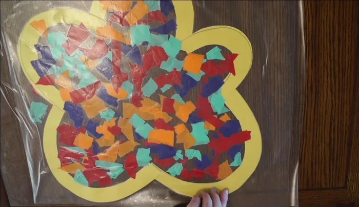 Cut out final design: Cut out the finished stained glass flower from the contact paper.