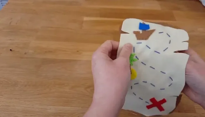 Place your dark brown felt backing wrong-sides together with your assembled map. Use a blanket stitch with brown thread to attach the backing, enclosing all the previous needlework.