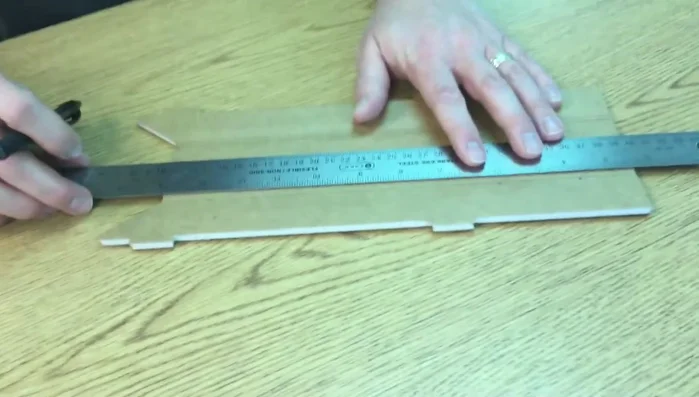 Using a straight edge, connect the marks to create a straight cutting line.