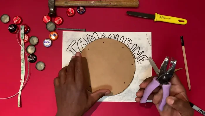 Punch holes using a heavy-duty hole punch.