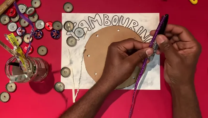 Tie the jingles into the holes of the cardboard tambourine.