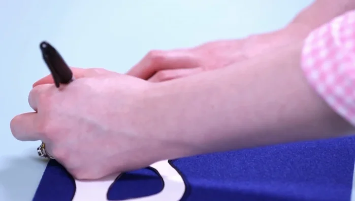 Cut a piece of elastic and attach it to the mask using squares of self-adhesive felt.