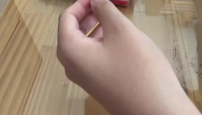 Stringing the beads onto the cord.