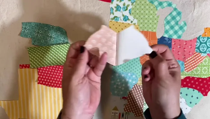 Remove backing from remaining states, aligning and ironing in sections.