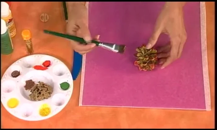 Apply sparkly glue to the tips of the pinecones, then sprinkle with gold glitter. Do this outdoors to minimize mess.