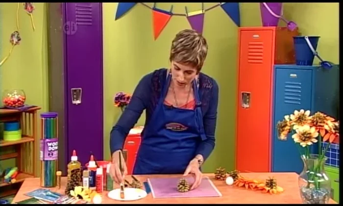 Apply sparkly glue to the tips of the pinecones, then sprinkle with gold glitter. Do this outdoors to minimize mess.