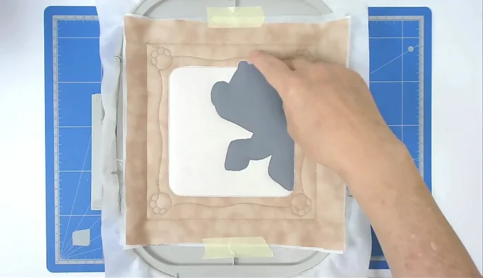 Zigzag stitch the raw edges of the animal and inner frame (number seven).