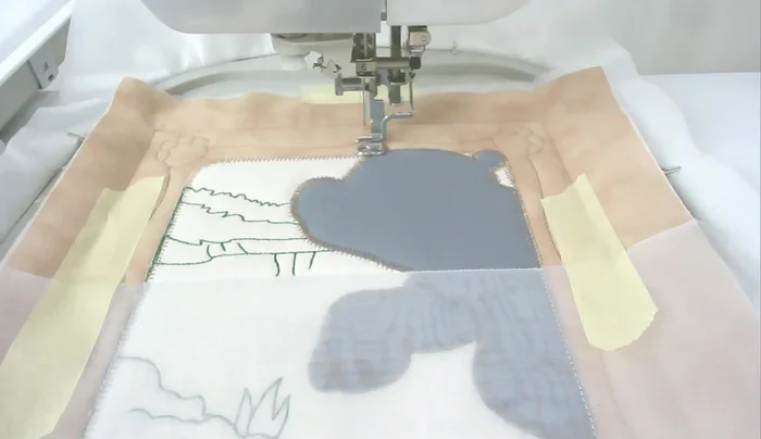 Satin stitch around the frame (number twelve).