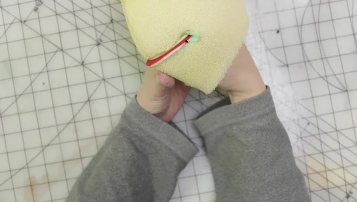 Add finger loops to the back of the head (if forgotten initially).